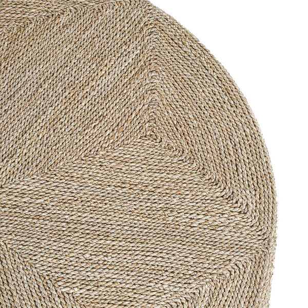 Close-up of a textured round rug with a natural fiber pattern on a white background