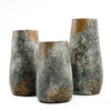 Three rustic stone vases on a white background