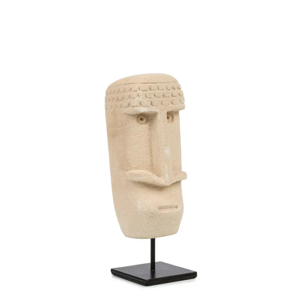Decorative statue of a face on a stand with a white background
