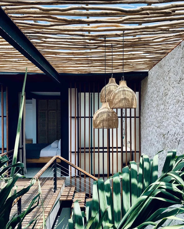 Indoor setting with woven pendant lights, wooden ceiling, and plants.