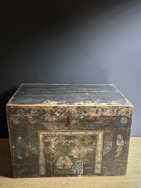 Vintage wooden trunk with decorative carvings on a dark background