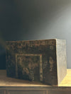 Decorative wooden box with intricate carvings on a dark background