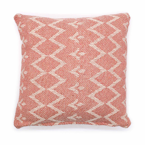 Red and white patterned pillow on a white background