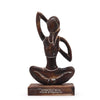Wooden sculpture of a person in a yoga pose with 'Stretch into Your Strength' text on a white background