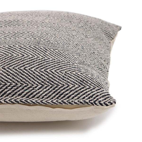 Textured pillow with a herringbone pattern on a white background