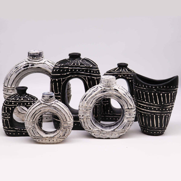 Set of black and white ceramic jars on a white background