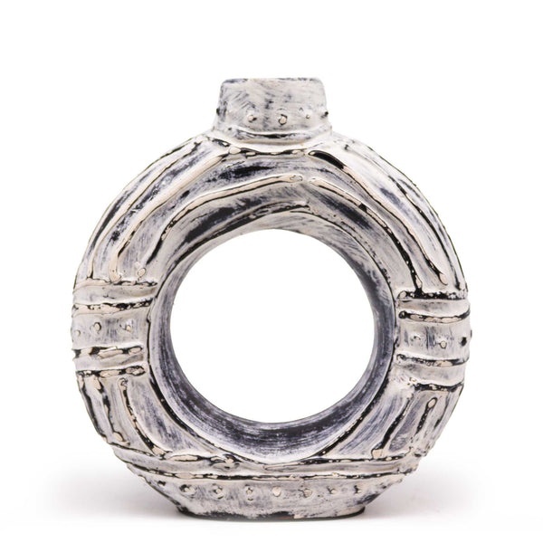 Silver ring with a textured band on a white background