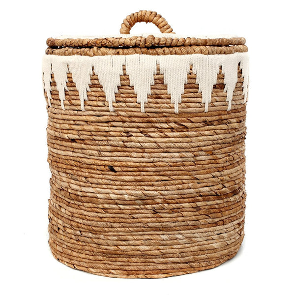 Woven basket with a lid and decorative tassels on a white background