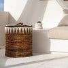 Woven basket on a white patio with a white wall and window in the background