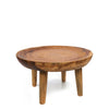 Wooden side table with a round top and four legs on a white background