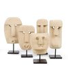 Set of five stone-like face sculptures on stands against a white background