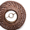 Decorative woven object with a central circular design on a white background