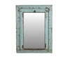 Vintage-style mirror with a weathered blue frame on a white background