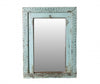 Decorative mirror with a light blue frame on a white background