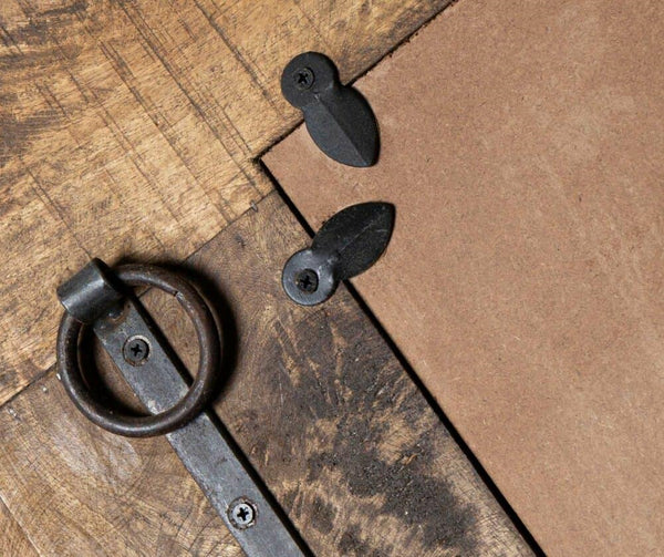 Close-up of metal handles on a wooden surface