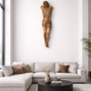 Modern living room with a sectional sofa, coffee table, and wall sculpture.