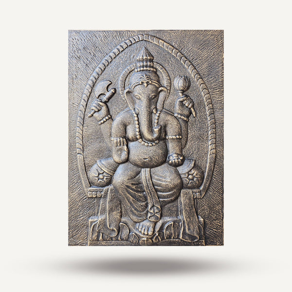 Decorative wall plaque with an embossed design of a deity on a wooden background