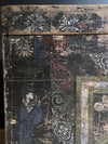 Vintage wooden box with intricate carvings and designs on a dark background