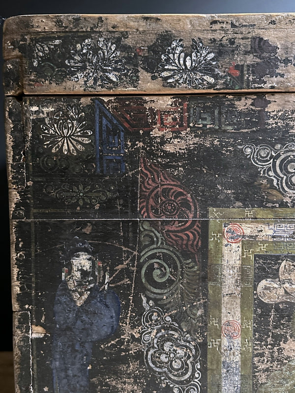 Vintage wooden box with intricate carvings and designs on a dark background