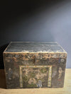 Vintage wooden trunk with decorative carvings on a dark background