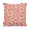 Red and white patterned pillow on a white background