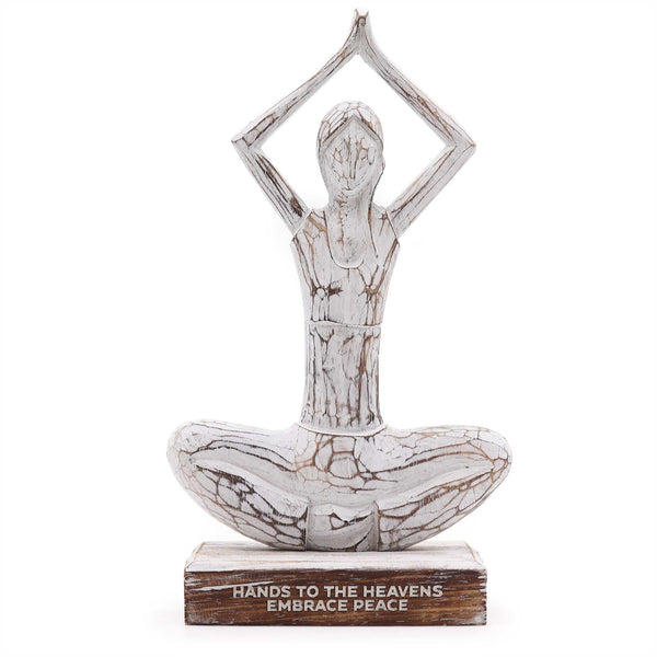 Decorative statue of a person in a yoga pose with 'Hands to the Heavens Embrace Peace' text on a white background