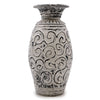 Decorative vase with black swirling patterns on a white background