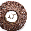 Brown woven decorative object on a white background
